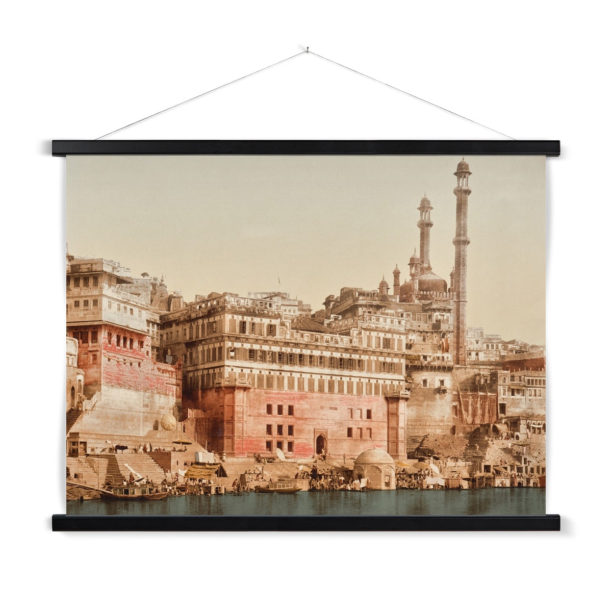 A vintage photo of a Mosque in Benares India, with a wooden hanger included. This print has a lovely soft patina and beautiful dusty colour palette.
A premium print + slimline wooden poster hanger with a discrete magnetic fastening to keep your prints perfectly secure. Hand-crafted from beautiful, solid wood, our picture hangers are ideal for displaying prints using a simple, contemporary design. When you want to update your style, simply change the print.
The Benares Mosque print features tan,