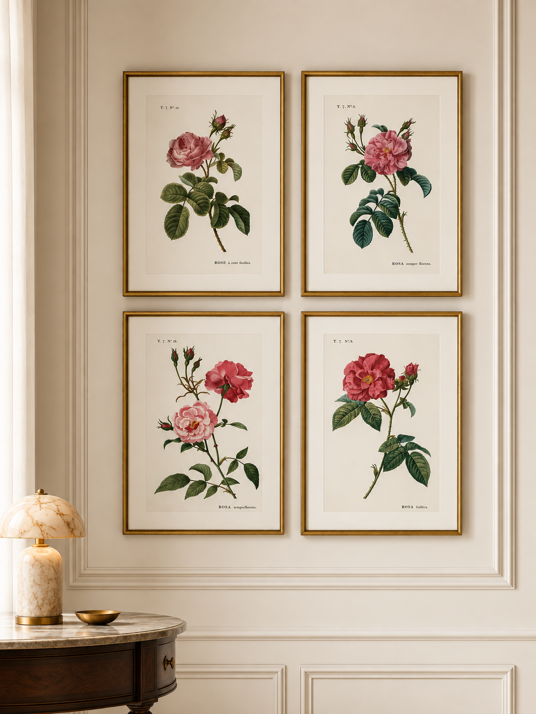 Four framed botanical rose prints arranged in a 2x2 grid on a cream paneled wall above a dark wood side table with a lamp.
