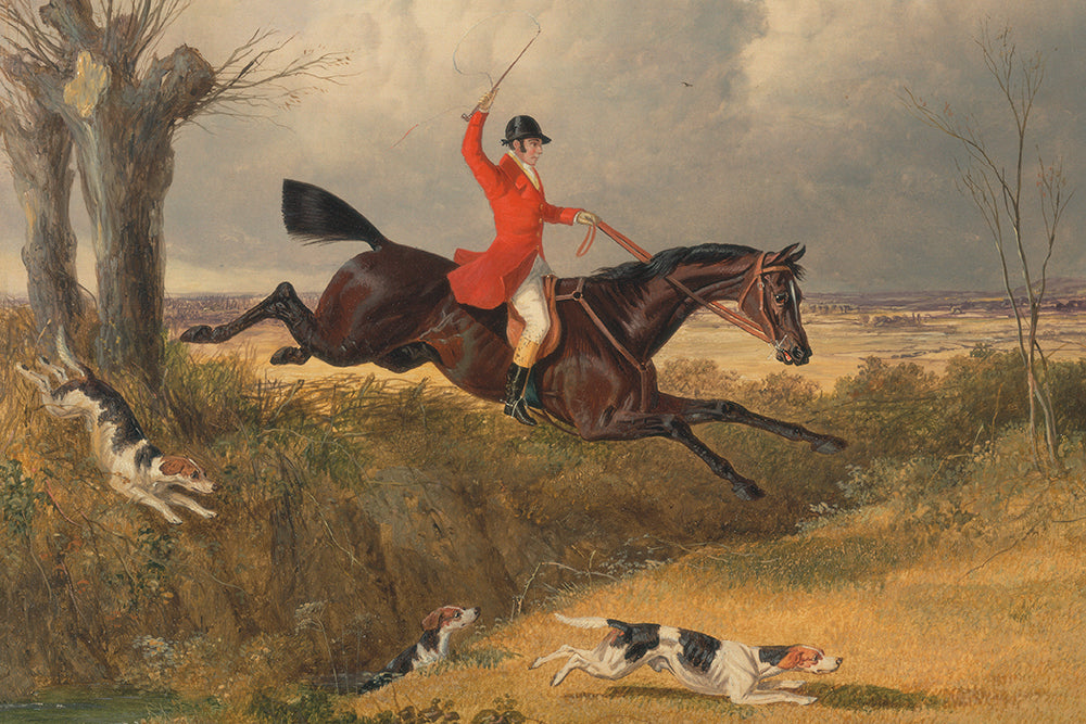 A vintage print capturing a horseman in a scarlet coat soaring over a hedge during a fox hunt. A delightful addition to a gallery wall, Ralph Lauren styled interior or childs room. This print has a lovely aged patina.

Featuring green, brown, tan, beige, black, white, grey, mauve and rust.
A museum-quality fine art print with a textured, matt finish, using giclée printing techniques that won't fade.