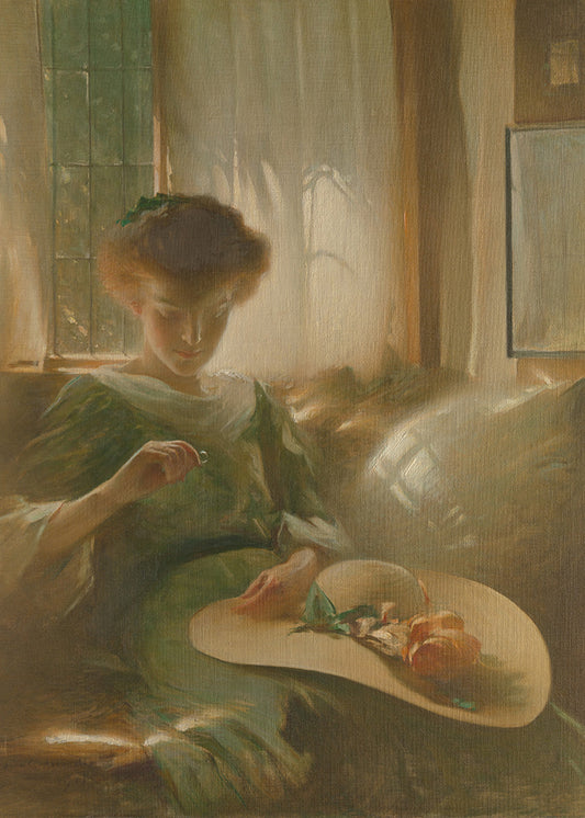Woman sitting by a window holding a straw hat with flowers, wearing a green dress.